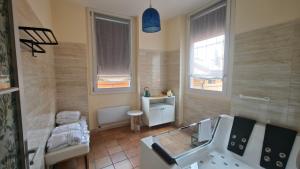 a bathroom with a tub and a sink and a mirror at Montefiori Luxury Suite & Spa in Bologna +36 photos