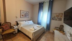 a small bedroom with a bed and a chair at Montefiori Luxury Suite & Spa in Bologna