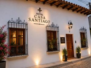 a white building with a sign on the side of it at Casa Santiago Son 2 in Antigua Guatemala
