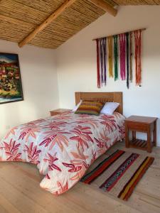 a bedroom with a bed and a table in it at Mountain View Lodge & Experience in Cusco