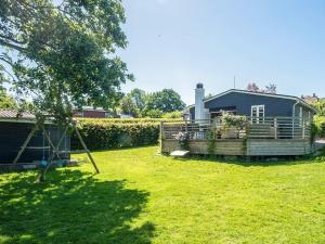 a yard with a house and a playground at 4 person holiday home in Haderslev in Haderslev