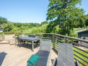 a patio with a table and chairs on a deck at 4 person holiday home in Haderslev in Haderslev