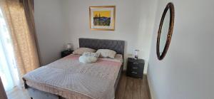 a bedroom with a bed with two stuffed animals on it at Pool, Sauna, Jacuzzi with Sea view - Apartment Josipa in Podstrana +61 photos