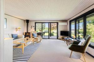 a living room filled with furniture and a large window at FY348-Svendborg-Storkenaebsvej-1 in Svendborg