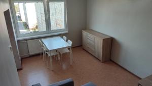 a small room with a table and chairs and a dresser at SkyView Studio Łódź - 11th Floor - Free Parking in Łódź