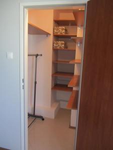 a closet with shelves and a treadmill in it at SkyView Studio Łódź - 11th Floor - Free Parking in Łódź