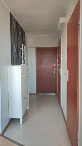 an empty room with a hallway with a door at SkyView Studio Łódź - 11th Floor - Free Parking in Łódź