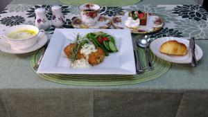 a table with a plate of food on a table at Utena Izukogen in Ito