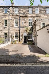 an old brick building with a driveway in front of it at Edinburgh Beach in Edinburgh