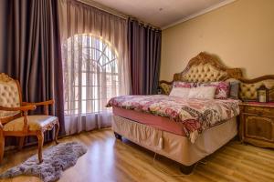 a bedroom with a large bed and a window at Kempton kingdom in Kempton Park