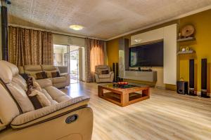 a living room with a couch and a tv at Kempton kingdom in Kempton Park