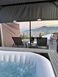 a swimming pool with chairs and a table and a patio at Džipsi glamping resort in Sarajevo