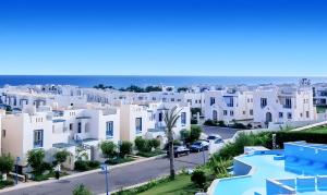 a view of a city with white houses at Chalet in Sahel Mountain view Diplo in Ras Elhekma