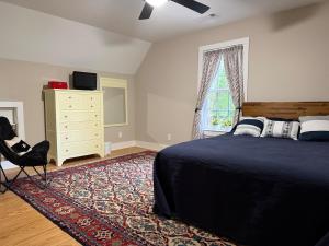a bedroom with a bed and a dresser and a window at Last house on the hill in Cleveland