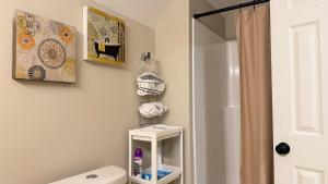 a bathroom with a white toilet and a shower at Last house on the hill in Cleveland +14 photos
