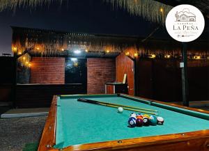 a pool table with balls on top of it at Cabañas nuevas La Peña in Taltal