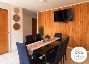 a dining room with a table and a tv on a wall at Cabañas nuevas La Peña in Taltal +4 photos