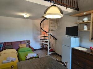 a living room with a couch and a refrigerator at La casetta del masso in Sorano