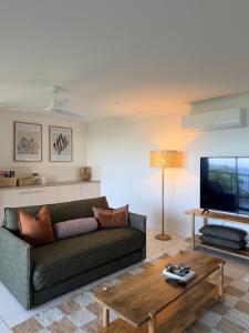 a living room with a couch and a coffee table at The Dune House in Tangalooma