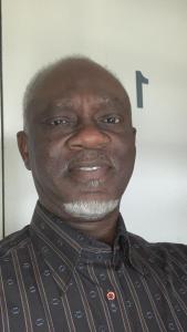 a man in a shirt is smiling at the camera at Antopom Heights & Suites in Sunyani