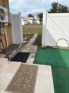a garden with green grass and a white fence at Oasis of the forest in Brandon +3 photos