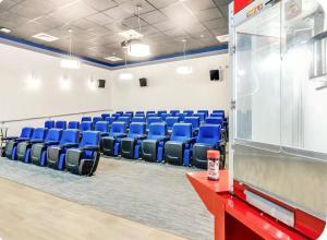 a conference room with blue chairs and a screen at The Caloosa Retreat in Fort Myers +41 photos