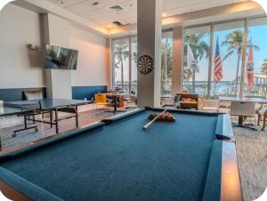 a billiard room with a pool table and tables at The Caloosa Retreat in Fort Myers