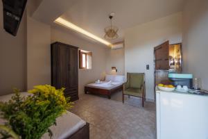 a room with a bed and a table and a chair at Aspalathos guest rooms in Vathia