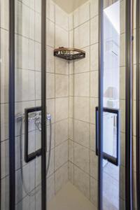 a bathroom with a shower with a shower head at Aspalathos guest rooms in Vathia +56 photos