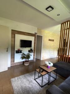 a living room with a couch and a table at Iskra DDUR in Gornji Milanovac