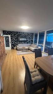a living room with a table and a couch at FeWo am Deich im Columbus Center mit Pool und Aufzug in Bremerhaven