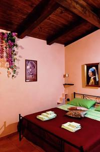 a bedroom with a bed with a red bedspread at I Santicelli in Morano Calabro