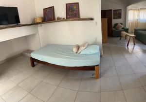 a bed in a room with a couch and a tv at Casa Lo de Linda in Lo de Marcos