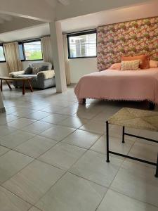 a bedroom with a bed and a tiled floor at Casa Lo de Linda in Lo de Marcos