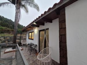 a patio with chairs and a hammock on a house at La Campestre in La Guancha