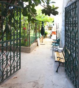 an entrance to a garden with a gate and a bench at Apartments Miranda in Split