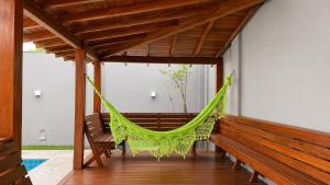 a hammock on the porch of a house at Recanto Veraneio - Londrina in Londrina