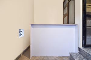 a white wall with a sign on the side of a building at Hotel O Pragati Inn in Jaipur