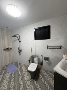 a bathroom with a toilet and a sink at Résidence sauver in Abidjan +134 photos