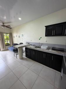 a kitchen with a sink and a counter top at Studio confort Uvita in Uvita