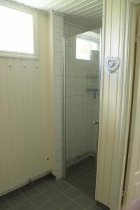 a shower with a glass door in a bathroom at Puoltikasvaara 3 in Puoltikasvaara