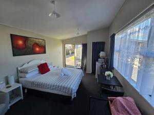 a hotel room with a bed and a window at Quiet Boutique Generous Breakfast in Palmerston North