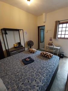 a bedroom with a large bed and a mirror at Kitnet - quarto - privativo in Itupeva +5 photos