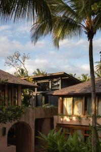a house with a palm tree in front of it at Moon Gang Ubud in Ubud