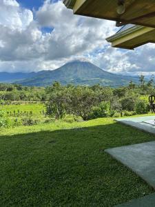 a view of a mountain in the distance from a house at Las Pavitas Arenal Suites in Fortuna