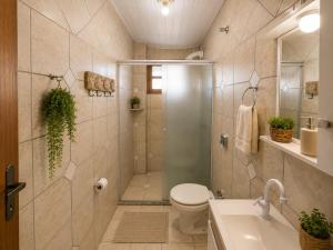 a bathroom with a shower and a toilet and a sink at GH Pinheira in Palhoça +41 photos