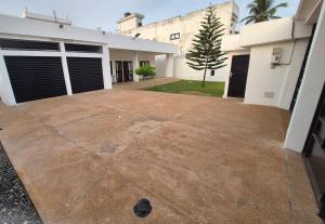 an empty driveway in front of a house at EmElla Manor in Komé +1 photo