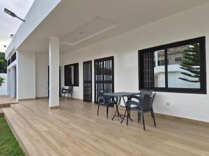 a dining room with a table and chairs at EmElla Manor in Komé