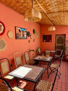 a room with tables and chairs in a room at Riad Maison Eden in Rabat