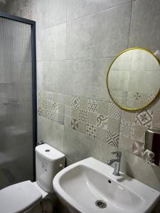 a bathroom with a sink and a toilet and a mirror at Riad Maison Eden in Rabat +57 photos